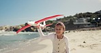 Plane flying, child and dad at beach on vacation with fun and playing with love, bonding and care. Family, toy airplane and happy kid with father together by the sea and ocean on holiday outdoor