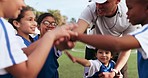 Kids, sport team and hands for teamwork outdoor on field with happiness and celebration in nature. Soccer, circle and excited face or smile for success, achievement and competition with win and pride