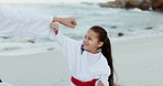 Beach, karate punch or child learning martial arts, fighting or taekwondo in fitness coaching. Challenge, kung fu or teacher teaching a kid, girl or student in workout, exercise or training at sea