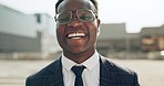 Happy, smile and face of professional black man in the city with good, confident and positive attitude. Happiness, ambition and portrait of young African male lawyer with glasses in an urban town.