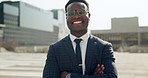 Happy, crossed arms and face of professional black man in the city with good, confident and positive attitude. Happiness, smile and portrait of young African male lawyer with glasses in an urban town