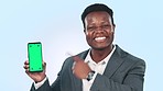 Pointing, employee and black man with a cellphone, green screen and connection on a blue studio background. Portrait, African person and entrepreneur with a smartphone, tracking markers and internet