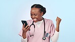 Doctor, woman and phone success, celebration and wow for healthcare news, results or announcement on blue, studio background. Excited african nurse or winner in medical achievement or goals on mobile