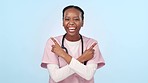 Happy black woman, nurse and pointing in advertising or marketing against a studio background. Portrait of African female person or medical doctor smile with thumbs up for deal or choice on mockup