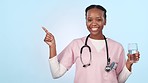 Happy black woman, nurse and pointing to list in advertising or marketing against a studio background. Portrait of African female person, healthcare or medical professional showing options or steps