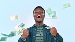 Man, winner and money rain for winning, celebration and lottery, bonus or financial freedom on a blue background. Face of excited african person with and wow, yes and cash in air of success in studio