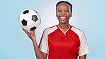 Happy, face and a black woman for soccer, sports or ready for a competition on a blue background. Laughing, athlete and portrait of a young female football coach or player for exercise or training