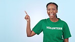 Black woman volunteer, point at mockup space and sign up for charity with help on blue background. Community service, donation with nonprofit work and information, registration and support in studio