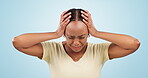 Woman, headache and trauma, anxiety and stress in studio, sad and frustrated with crying on blue background. Overwhelmed, scared with crisis and fail, terror and disaster with alarm and mental health