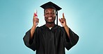 Black man graduation, education and pointing up at college graduate info, college news or university direction. Diploma, studio portrait and student gesture at academy advertising on blue background