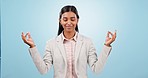 Calm, meditation and woman breathing in a studio for zen, positive and peaceful mindfulness. Yoga, balance and young Indian female person with relax for chakra energy isolated by blue background.