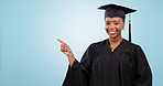Graduation, woman pointing and space for education, learning or college presentation on a blue background. Face of african student or graduate information, registration steps and okay hands in studio