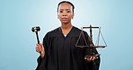Judge woman, face and scale for law in studio for service, gavel and justice by blue background. African legal expert, balance and hammer for decision, negotiation and portrait in courtroom job
