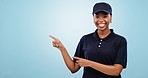 Happy black woman, pointing and advertising in marketing against a blue studio background. Portrait of African female person or employee showing notification, deal or sale discount on mockup space