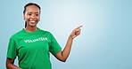 Volunteer, information and woman pointing to presentation for sign up, help or nonprofit support on advertising space. Face of african person with NGO registration or steps on blue, studio background