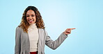 Happy business woman, pointing and list in advertising, marketing or mockup against a blue studio background. Portrait of female person or employee smile showing advertisement, product or information