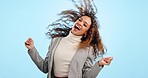 Hair, dancing and happy woman in celebration fro winning, excited and isolated in a studio blue background with smile. Joy, happiness and portrait of young person winning an achievement with energy