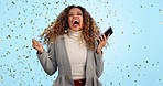 Woman, phone and confetti celebration in studio for prize, profit or trading with goal, crypto or stocks by blue background. Winner girl, smartphone and yes for fintech app, esports gambling or lotto