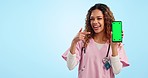 Mockup, green screen and portrait of woman doctor pointing at phone in studio for advice, info or contact. Smile, chromakey and nurse with online review, feedback or medical guide on blue background.