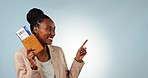 Pointing, flight and a black woman with a ticket for travel, presentation or information. Happy, mockup space and portrait of an African girl with a gesture and excited about documents for a holiday