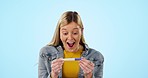 Pregnancy test, surprise and excited woman celebrate results in studio isolated on a blue background mockup space. Wow, happy and pregnant person in celebration of success of good news for future mom