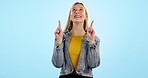 Woman, portrait and point up for mockup smile in studio for marketing presentation, idea or advertising. Female model, blue background and smile for product deal sale, promotion space or announcement