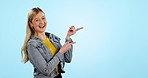 Pointing, smile and face of woman in a studio with mockup space for marketing, promotion or advertising. Happy, mock up and portrait of female model from Canada with steps gesture by blue background.