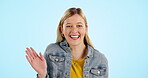 Face, wave hand and excited woman in studio isolated on blue background mockup space. Portrait, hello and palm of happy model greeting to welcome, waving hi or goodbye sign language in communication