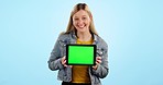 Woman, tablet and green screen with smile in studio, promotion and branding for app by blue background. Girl, student and face with digital touchscreen, mockup and space for logo, sign and feedback