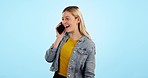 Smile, phone call and woman with connection, speaking and communication on a blue studio background. Person, happy girl and model with a smartphone, network and digital app with discussion or talking