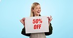 Happy woman, billboard and sale for discount price or promotion against a blue studio background. Portrait of excited female person with poster or sign for store special, deal off or promo on mockup