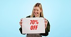 Happy woman, billboard and sale for promo deal or discount price against a blue studio background. Portrait of excited female person with poster or sign for store special, promotion or off on mockup