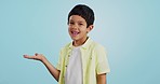 Kid, smile and happy for presentation in studio on blue background with mockup for product placement. Youth, boy and excited for opportunity, offer or deal on app, social media or digital marketing