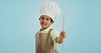 Happy, face and child with a spoon for baking, young chef or getting ready for the kitchen. Smile, boy kid or portrait with equipment for cooking, future career or preparation on a studio background