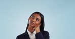 Business woman, thinking and ideas in studio with mockup space for promotion by blue background. Entrepreneur, looking up and brainstorming for decision, choice or plan with confused face for memory