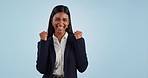 Business woman, fist celebration and studio with smile, goals and success with face by blue background. Trader, entrepreneur and winner with cheers for finance, profit or increase for stock revenue