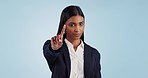 Finger, no and face of business woman in studio with stop, warning or rejection on blue background. Protest, hand and portrait of female entrepreneur with deny emoji, threat or not allowed gesture