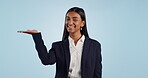 Advertising, palm and portrait of business woman with promotion or deal isolated in a studio blue background. Smile, happy and employee showing announcement information in offer presentation