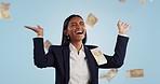 Business woman, winner and money rain for success, celebration and lottery, bonus or financial freedom on a blue background. Excited worker or entrepreneur in studio with wow or smile for cash in air