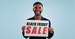 Man, excited and poster sign for Black Friday sale in mockup, discount and promotion or deal. Happy black person, portrait and cheap retail prices from marketing, advertising and commercial on board