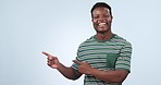 Black man, face and pointing to advertising in studio of information, deal and choice on blue background. Happy portrait, model and presentation of mockup, announcement and feedback of news about us