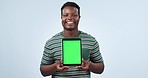 Face, man and green screen space on tablet in studio for advertising sign up offer on blue background. Happy african model, portrait and tracking markers for digital marketing, newsletter and launch