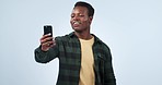 Showing, black man and cellphone with wave, hello or connection with digital app on a blue studio background. African person, guy or model with smartphone, greeting or showing with network or contact