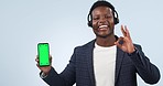 Black man, call center and phone green screen in advertising or customer service against a studio background. Portrait of African person or consultant showing mobile smartphone display, app or mockup