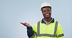 Engineer, palm space and man advertising in studio isolated on a blue background mockup. Portrait, hand and happy African architect marketing construction, building promotion and commercial in helmet