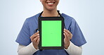 Doctor hands, tablet green screen and happy person for online commercial, hospital promotion or medical clinic notification. Studio branding, UI mockup space and nurse presentation on blue background