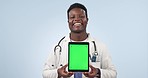 Happy black man, doctor and tablet with green screen in advertising against a studio background. Portrait of African male person or medical healthcare surgeon showing technology app display or mockup