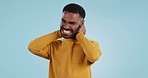 Neck pain, stress and man in studio frustrated with arthritis, tension or pressure on blue background. Shoulder, anxiety and face upset male model with burnout, osteoporosis or fibromyalgia injury