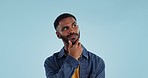 Man, thinking and planning idea with choice and decision in studio on blue background and questions. Brainstorming, person and problem solving ideas or why with solution and remember on mock up space