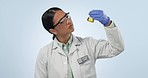 Studio, woman or scientist with solution in glass for lab test in chemistry, biotech or medical research. Chemical study, vaccine development and science, doctor with liquid in jug on blue background